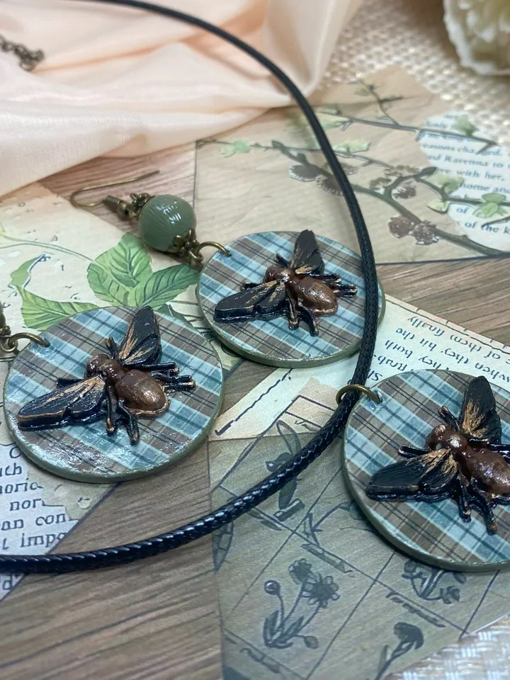 Author's set of handmade jewelry.Earrings and pendant on a cord with voluminous flies.