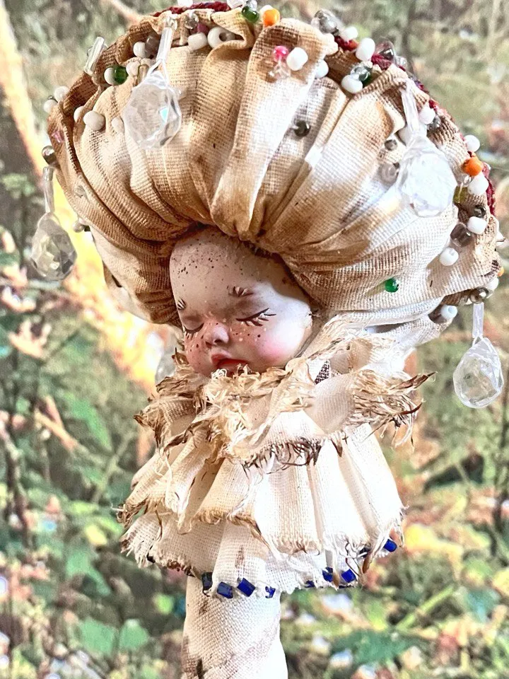 Art doll Mushroom. Unusual handmade figurine. Sleeping child-toy in the image of a fly mushroom. Unique statuette is made of fabric and polymer clay, decorated with beads and beads. An art object for your interior and collection