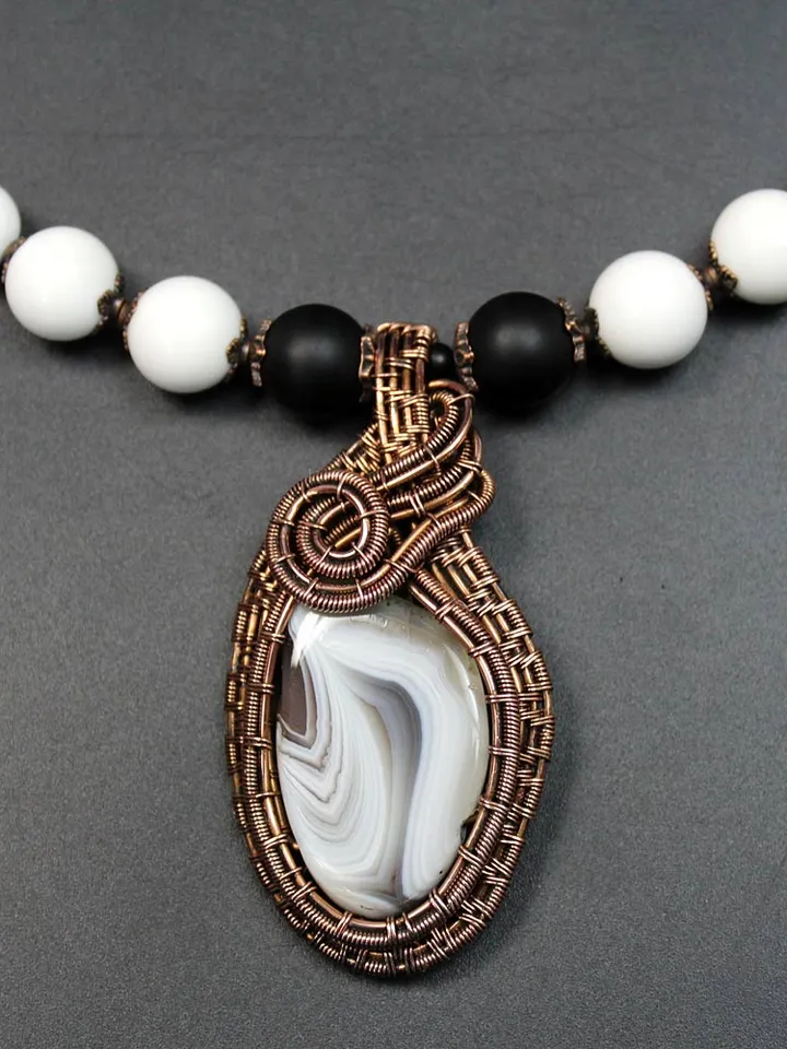 Handmade necklace with pendant made of stones and copper wire