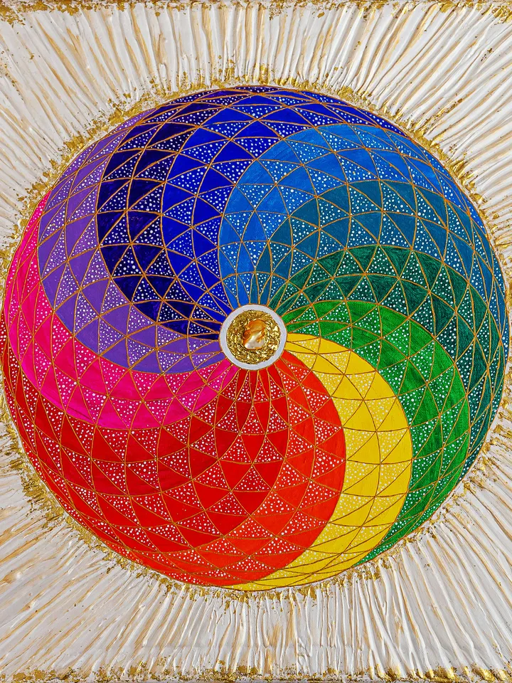 The rainbow sphere, with sacred geometry and white rays surrounding it