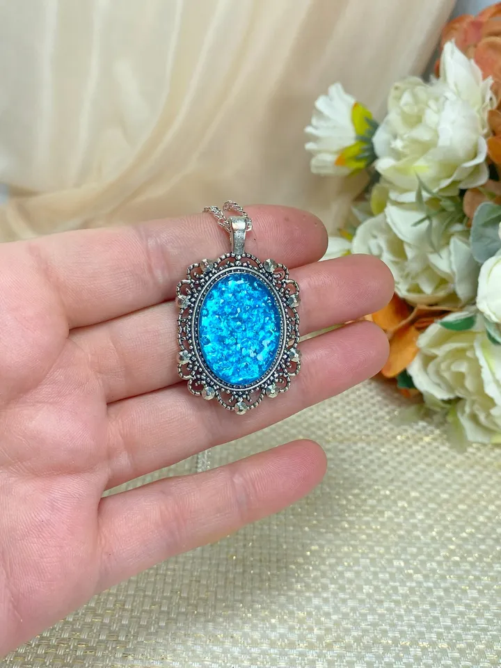 Bright, turquoise pendant on a handmade cord. Handmade jewelry with turquoise rhinestones.