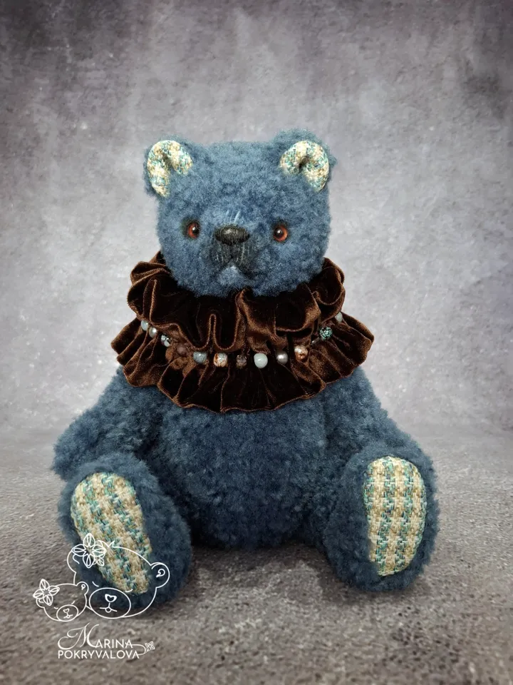 Blue teddy bear. Handmade toy. Plush bear.