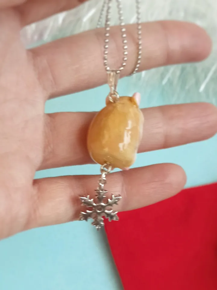 A small handmade hamster necklace in red and white color