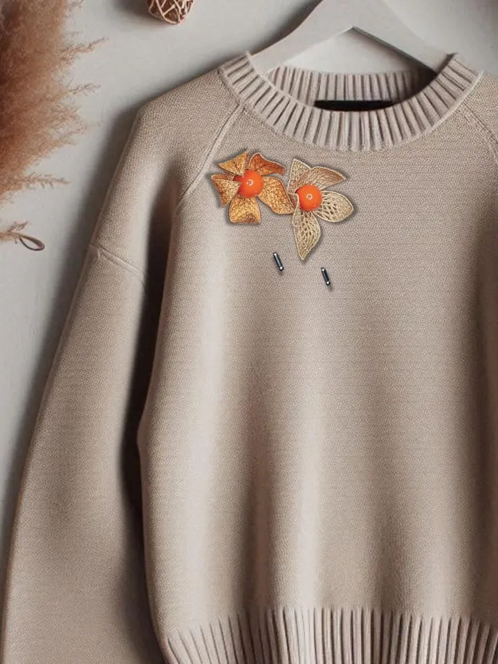 Machine embroidery design of paired Physalis brooches