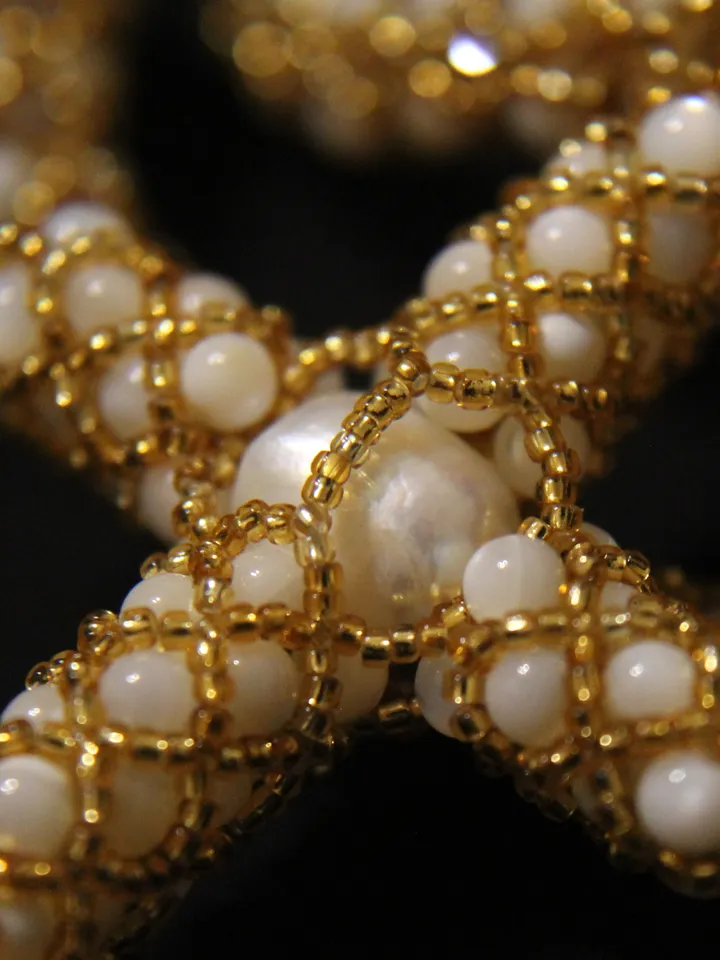 Pendant in the form of a cross woven pearls, mother-of-pearl and beads