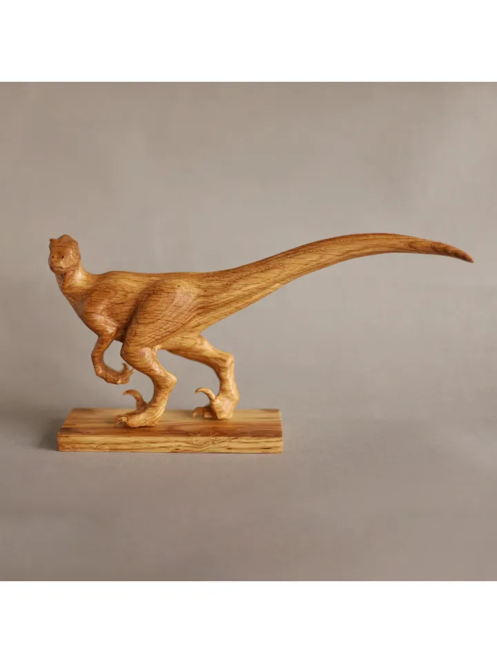 Wooden hand carved dinosaur velociraptor