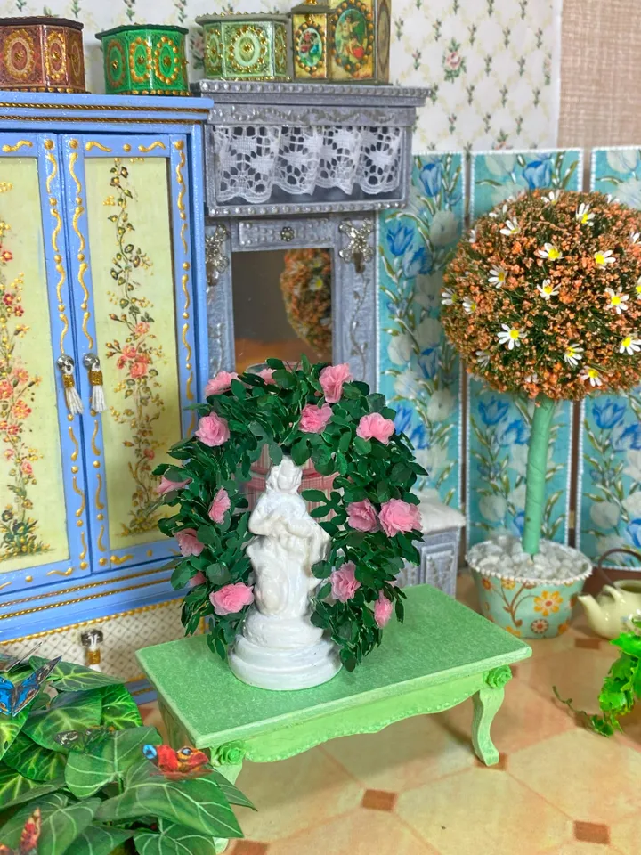 A figurine with delicate roses for a dollhouse and a park area. Dollhouse miniature. 1:12.