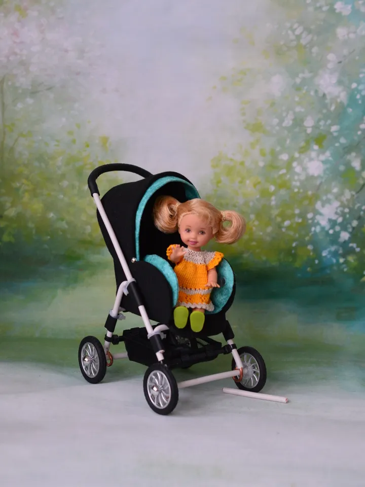 Miniature toy stroller for dolls in 1/6 scale. Accessories for small dolls and poupins. Pram for Barbie doll.