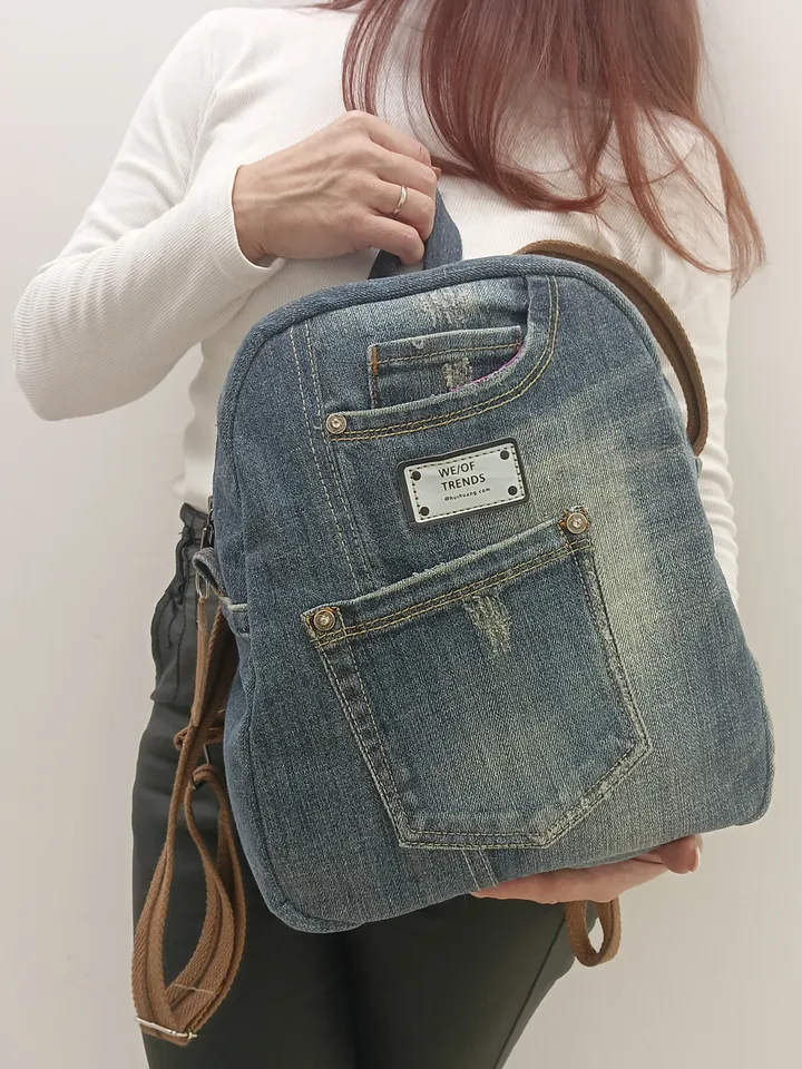 Denim backpack with 100 percent cotton lining, handmade, recycled jeans, 5 pockets on the outside, 2 deep pockets on the inside, strong webbing straps, decorated with a label and genuine leather on the zipper puller. size: height 30 cm. *25*12cm