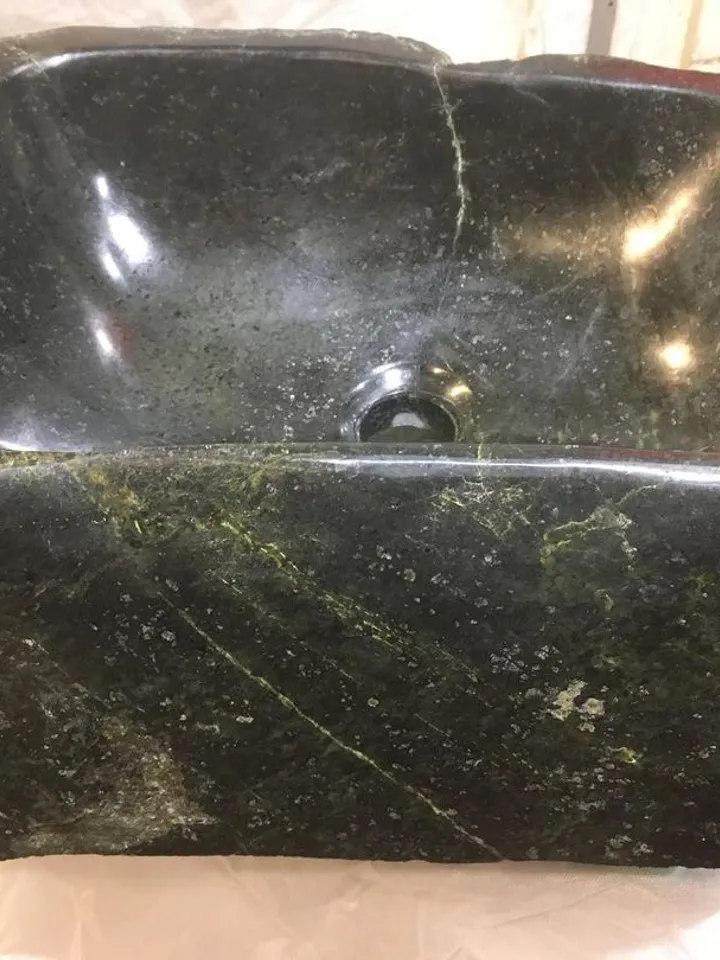 An exclusive sink made of natural stone is a coil.