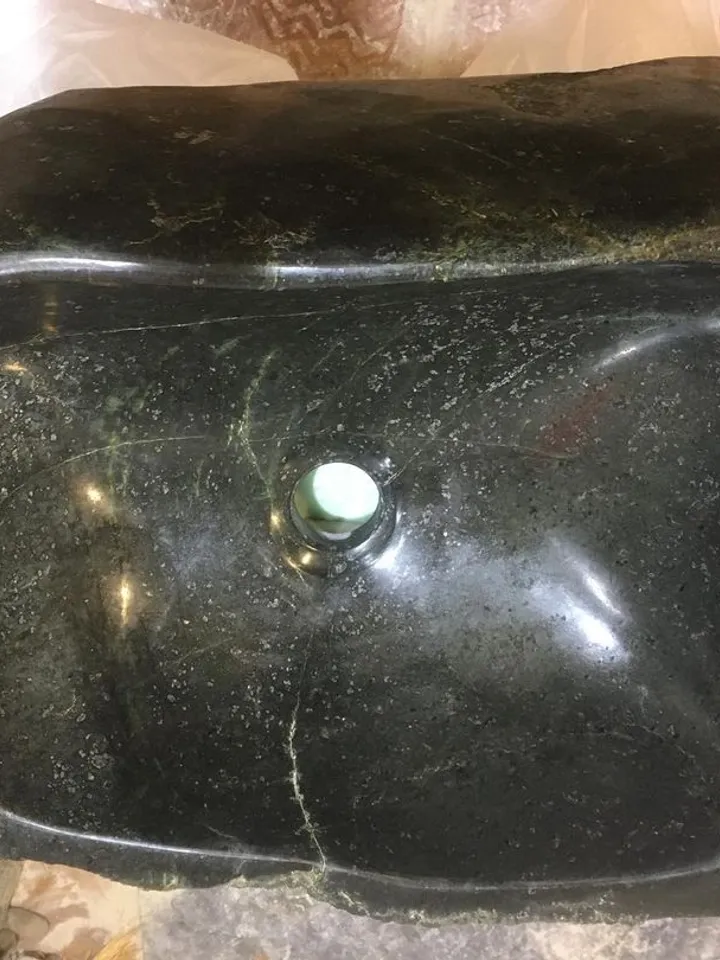 An exclusive sink made of natural stone is a coil.