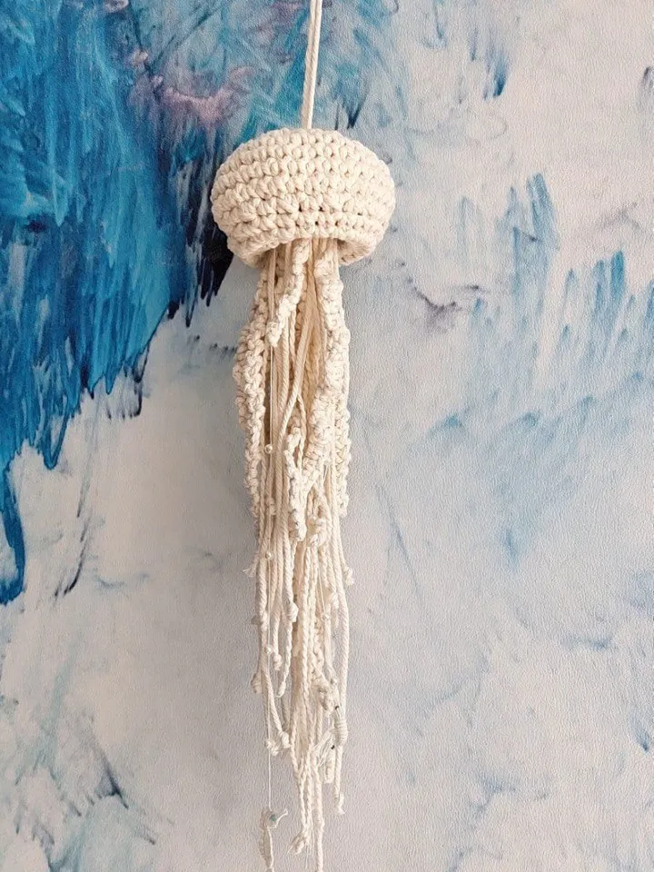 Pendant decoration in the shape of a jellyfish made of macramé. Modern macramé. Home decor in coastal style. crochet jellyfish