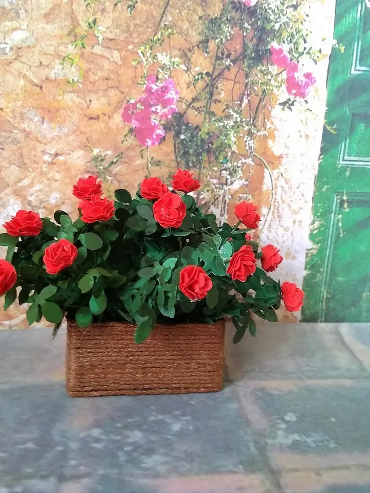 Miniature roses in a flowerpot. Dollhouse miniature.