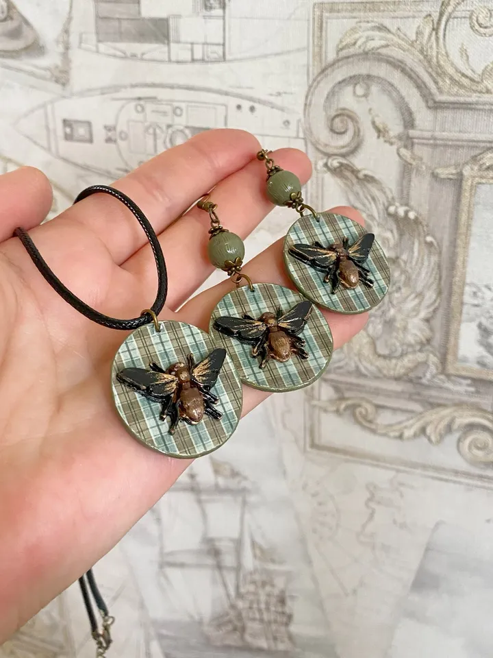 Author's set of handmade jewelry.Earrings and pendant on a cord with voluminous flies.