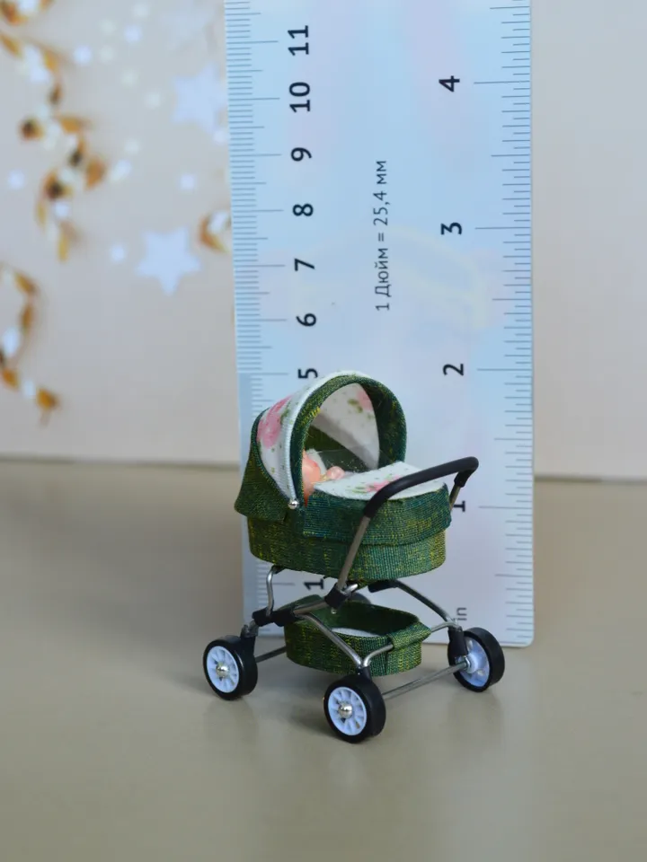 Miniature toy doll stroller in 1/24 scale. Complete with baby doll.