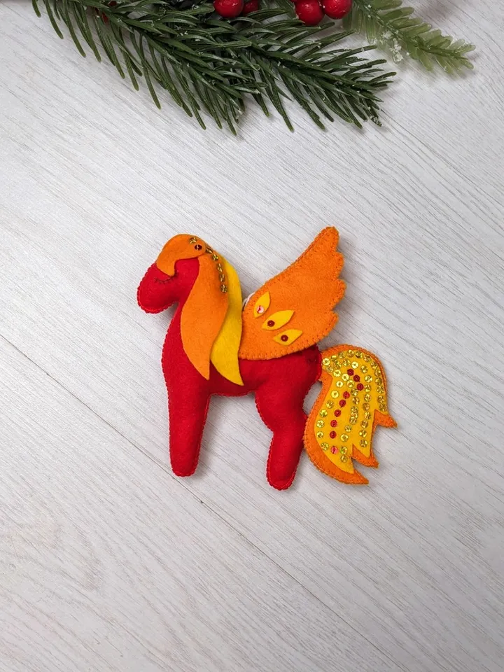 Pegasus in ancient Greek mythology is a winged horse, a favorite of the muses. Felt toy Red fiery Pegasus