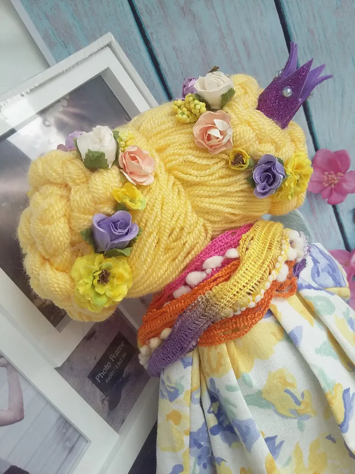 Doll Princess in the crown with an elephant in her hands, with yellow hair, beautiful, interior, birthday present, holiday