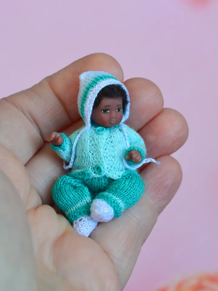 Miniature doll child in 12th scales. A baby for the dollhouse. Baby in a blue suit.