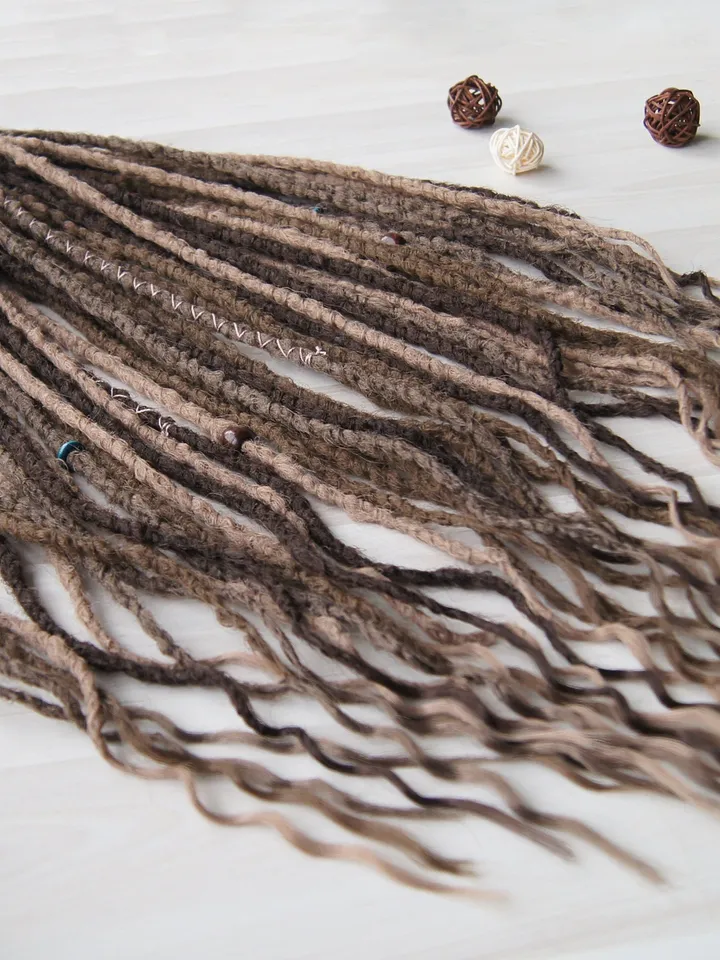 Wavy Synthetic Dreadlock Extensions in Ash Brown with Boho Beads and Wraps for Natural Looking Festival Hairstyles