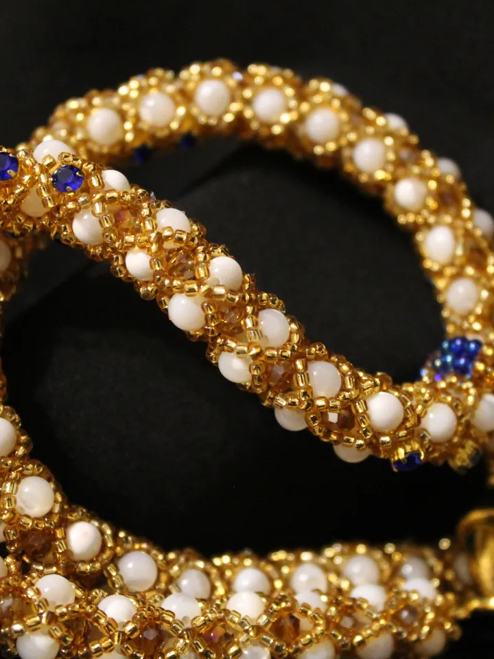 Pendant in the form of a cross woven pearls, mother-of-pearl and beads