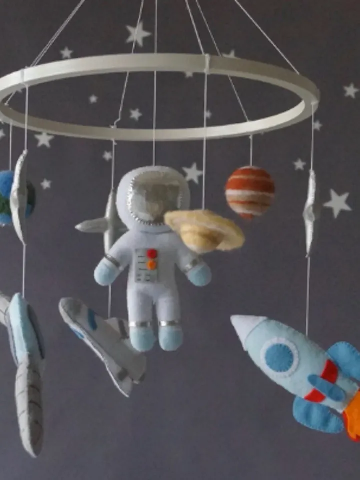 A space mobile for astronaut's nursery, a Shuttle and a rocket made of felt for the decor boy's room