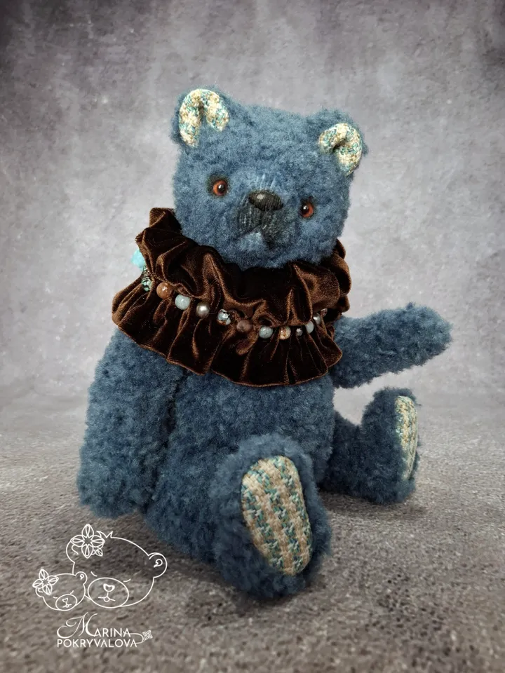 Blue teddy bear. Handmade toy. Plush bear.