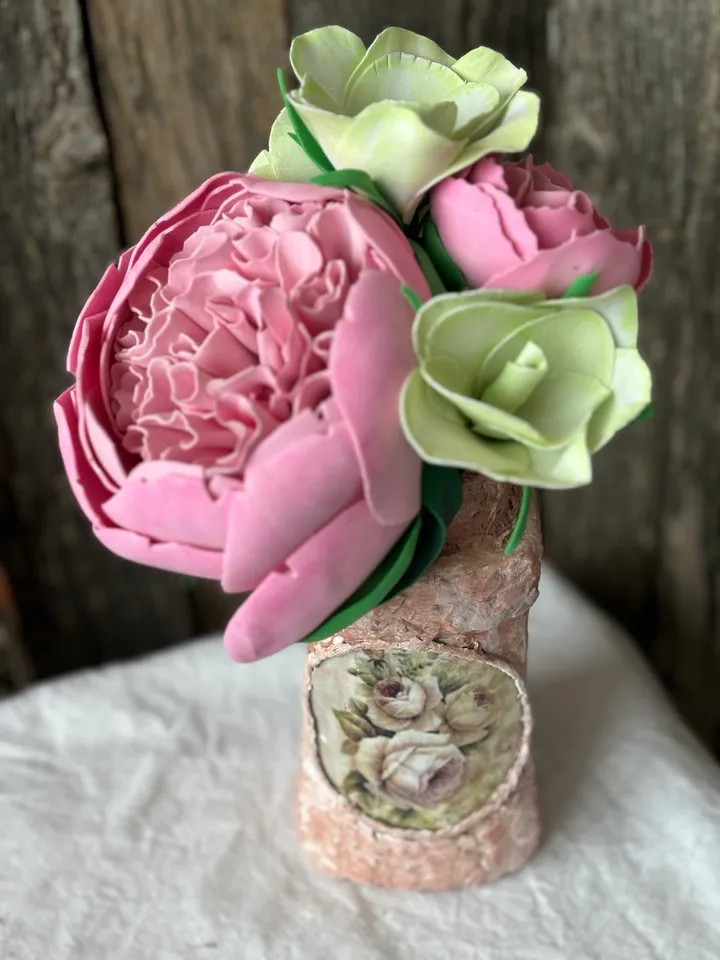 Delicate composition of pink peonies and eustomes in a handmade vases