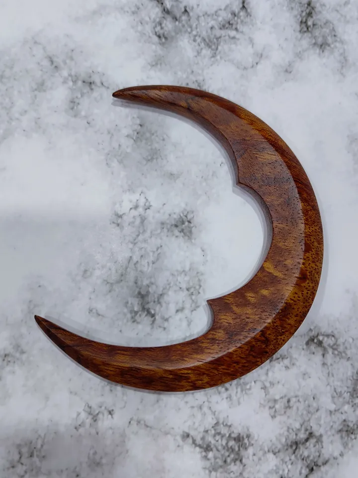 Hair bun pin in the shape of a moon.
