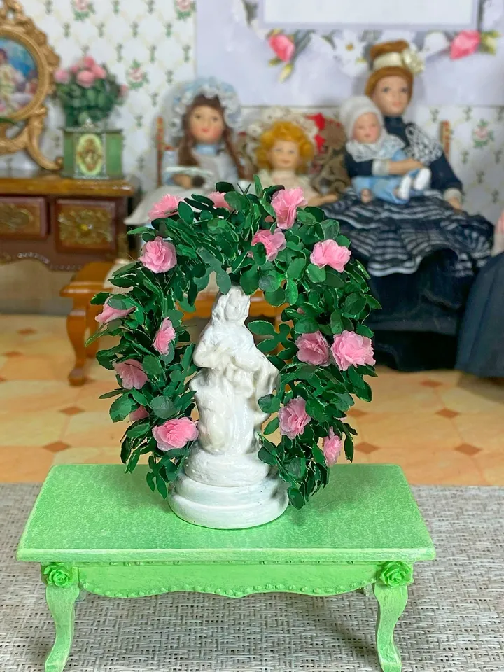 A figurine with delicate roses for a dollhouse and a park area. Dollhouse miniature. 1:12.