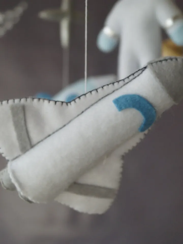A space mobile for astronaut's nursery, a Shuttle and a rocket made of felt for the decor boy's room