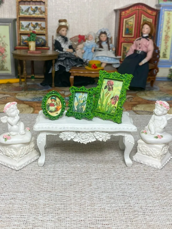 A set of frames with images of flowers. Dollhouse miniature. 1:12.