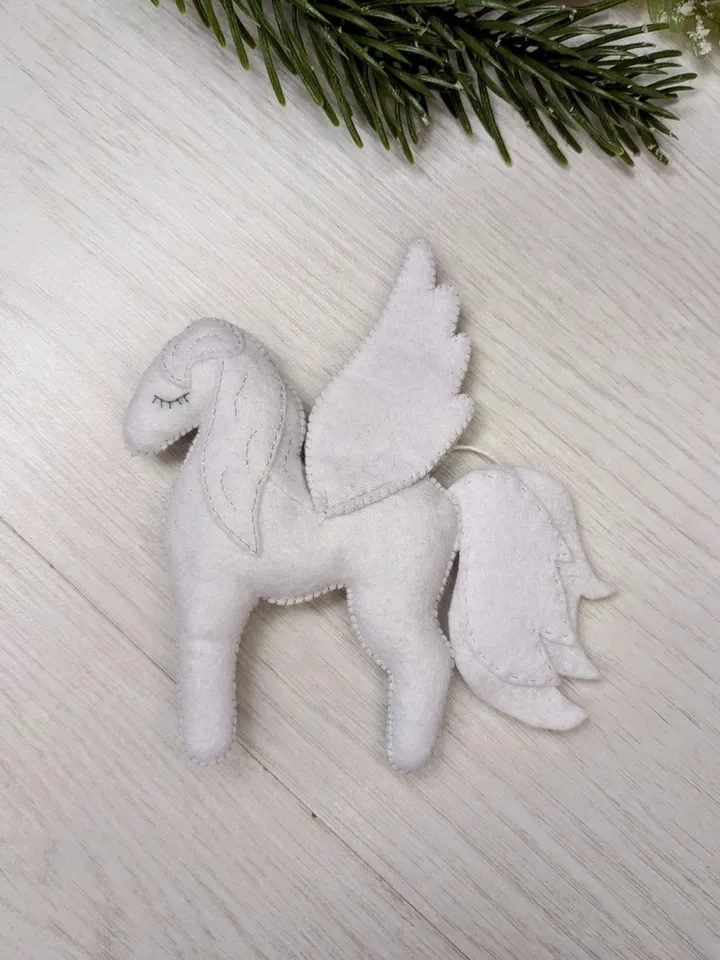 Pegasus in ancient Greek mythology is a winged horse, a favorite of the muses. White Pegasus felt toy
