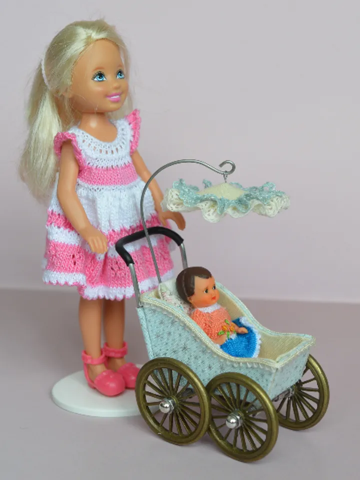 Miniature toy stroller for a little doll. Pram for the little poopsie.