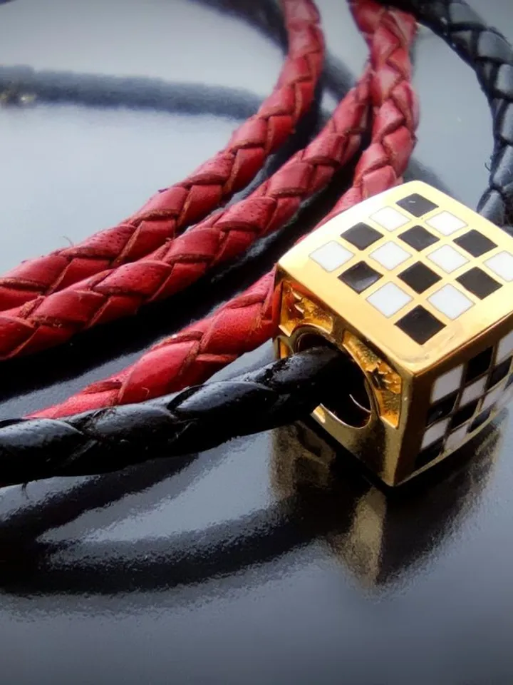 Leather braided bracelet with a chess bead. Silver, gold plated, hot enamel.