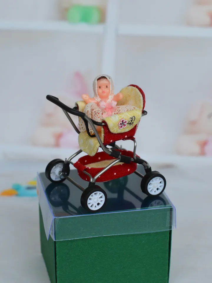 Miniature toy doll stroller in 1/24 scale. Complete with baby doll. Red handmade stroller.