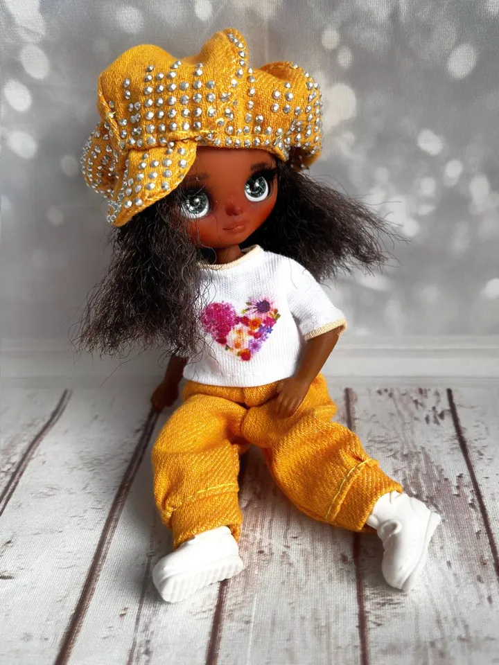 Petite Blythe with dark skin. Adorable miniature doll on an articulated body.