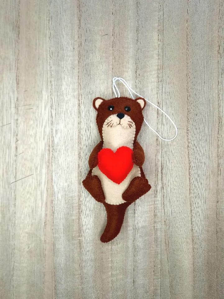 Felt otter. Otter with a red heart. Otter toy. New Year's decor otter. New Year's ornament otter