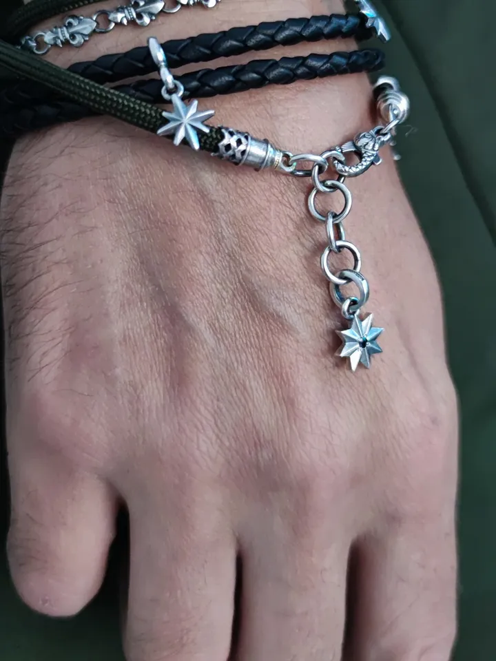 Designer multilayer bracelet with elements of chain, genuine leather and paracord