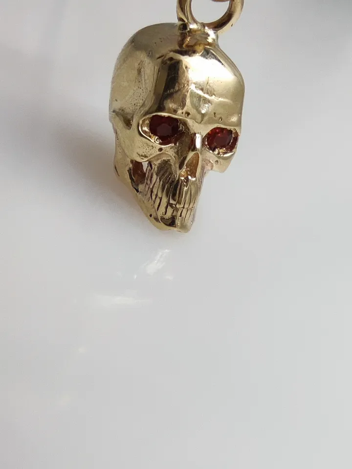 Skull pendant with inlaid natural garnets