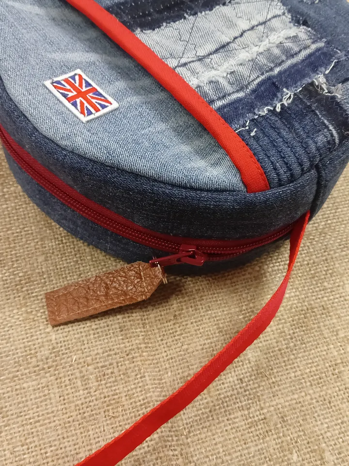 Cute handmade denim round crossbody bag with Red belt, brown polka dot cotton inside, pockets inside and outside, leather zipper stripe, weight only 160 grams, very light. A handbag for walks, excursions, and travel.