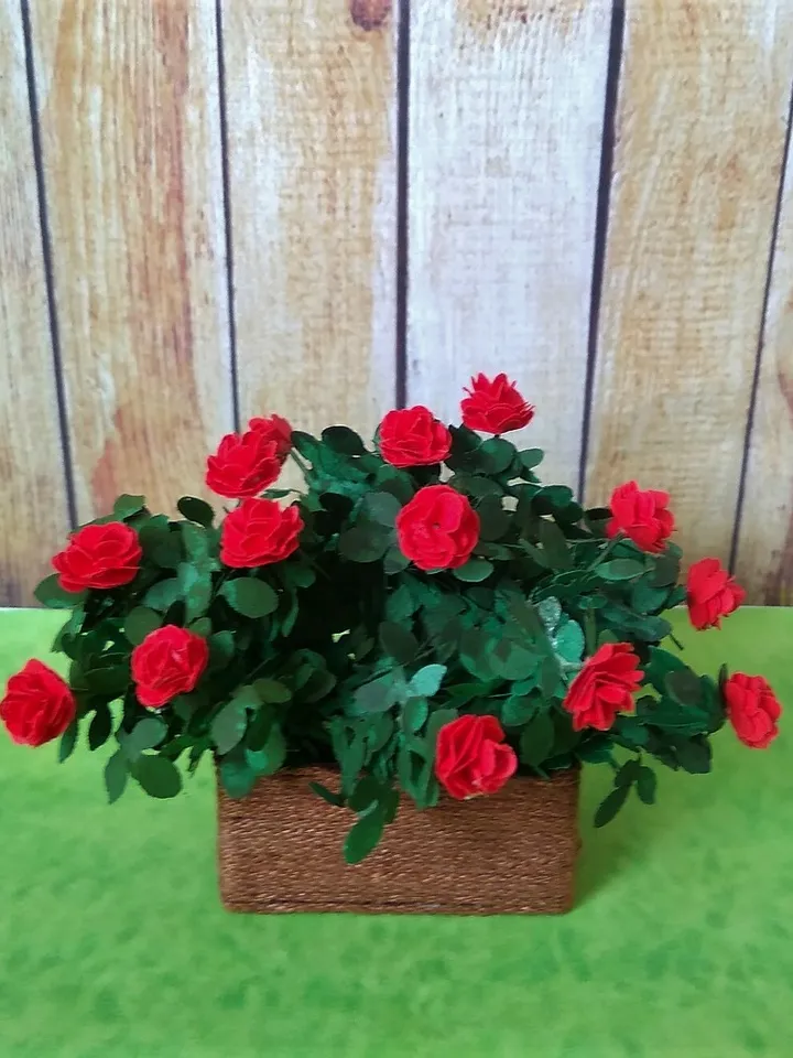 Miniature roses in a flowerpot. Dollhouse miniature.