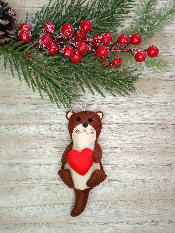 Felt otter. Otter with a red heart. Otter toy. New Year's decor otter. New Year's ornament otter