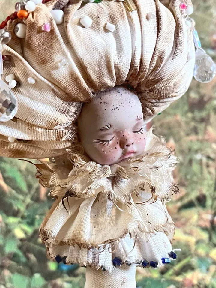 Art doll Mushroom. Unusual handmade figurine. Sleeping child-toy in the image of a fly mushroom. Unique statuette is made of fabric and polymer clay, decorated with beads and beads. An art object for your interior and collection
