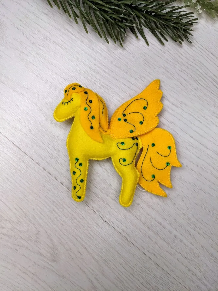 Pegasus in ancient Greek mythology is a winged horse, a favorite of the muses. Yellow felt toy Pegasus
