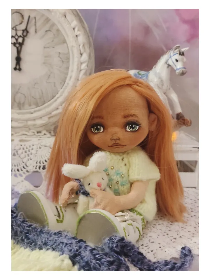 Cute little girl doll with a bunny