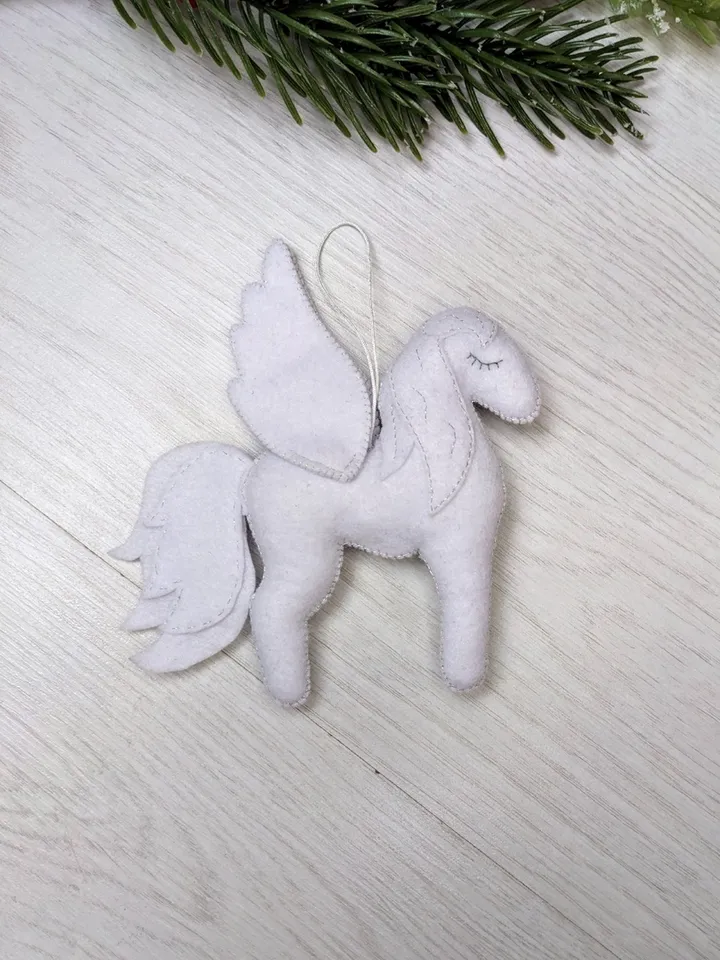 Pegasus in ancient Greek mythology is a winged horse, a favorite of the muses. White Pegasus felt toy