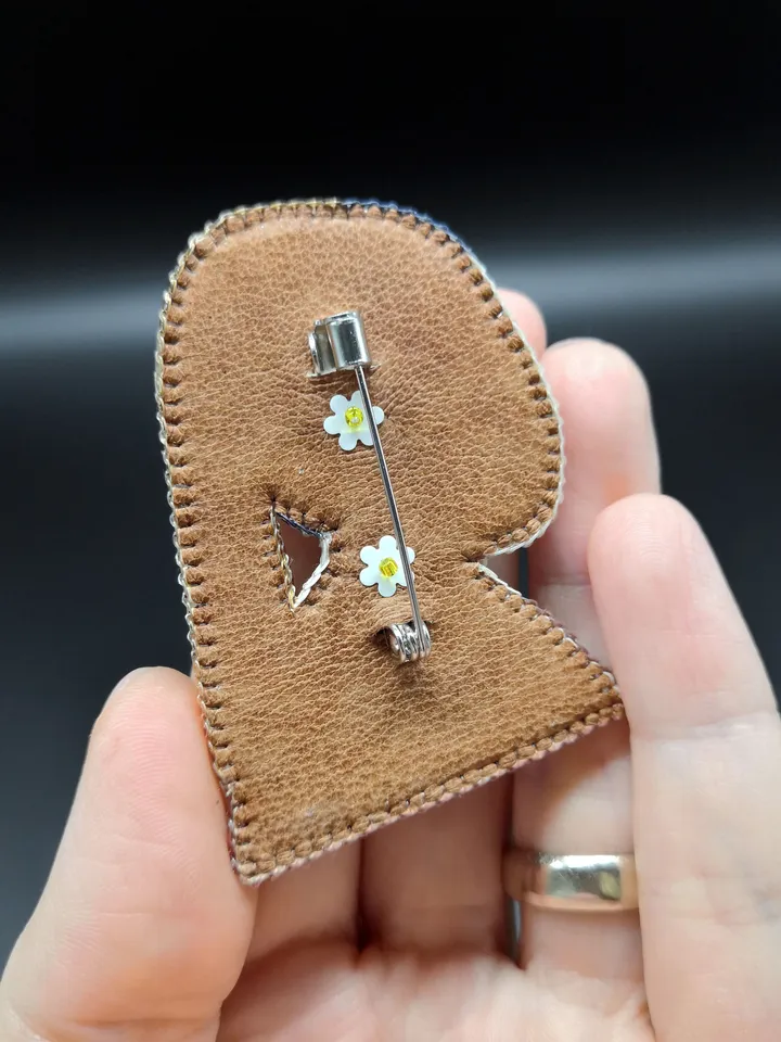 Brooch of a woman with a pearl earring