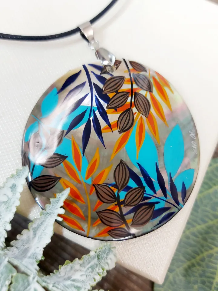 Artistic Expression in Nacre: Abstract Botanical Hand-Painted Mother-of-Pearl Pendant - Captivating Blue and Orange Leaf Motif