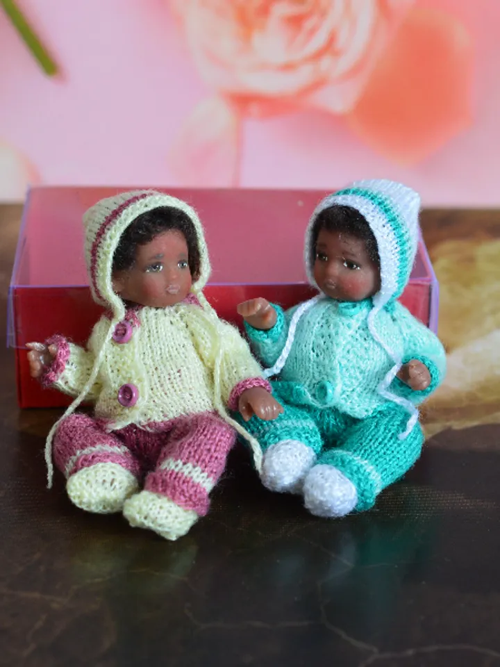 Miniature doll child in 12th scales. A baby for the dollhouse. Baby in a blue suit.