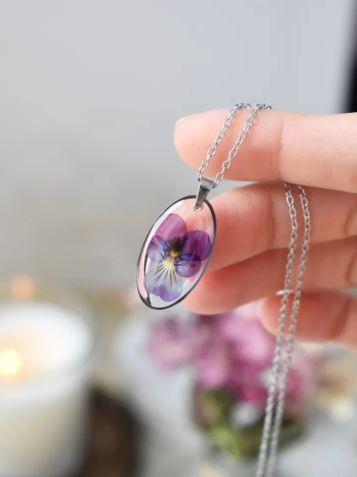 Pendant with a real pansy flower in the resin. Tiny viola flower necklace.